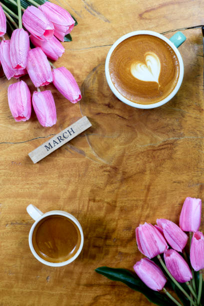 istock flat lay. coffee mug heart shape with tulip bouquet on wooden table 1206115956
