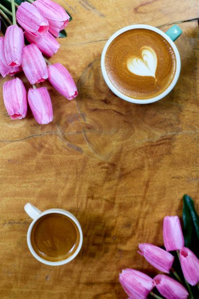 istock flat lay. coffee mug heart shape with tulip bouquet on wooden table 1206115957