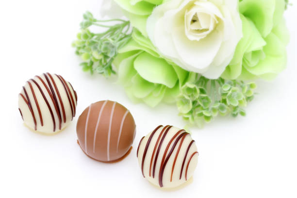 Sweet chocolate balls with white rose flower for Valentines day