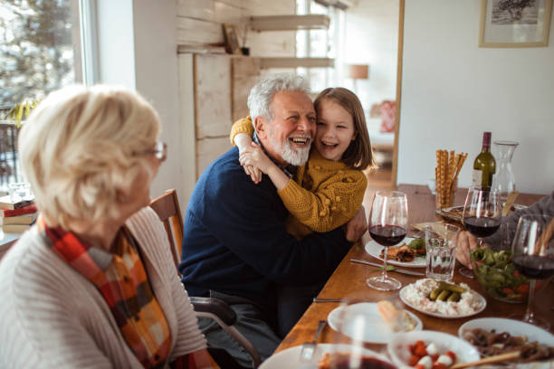 Grandparents Home Close up of a granddaughter spending time with her grandparents during the holidays grandpa eating stock pictures, royalty-free photos & images