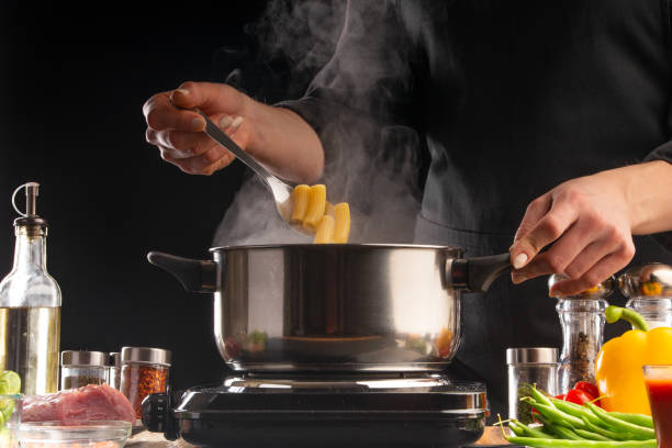 Cooking Italian pasta, sauce. Freeze on the move, vegetables and meat. On a black background, horizontal photo. Advertising, cooking, recipe book, home meals, restaurant business.