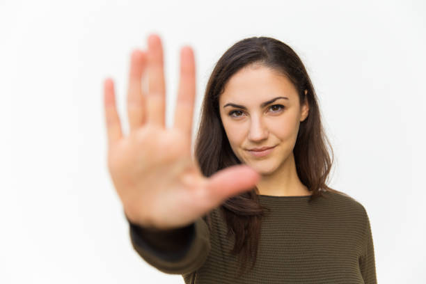 istock Serious young woman showing stop gesture 1206135435