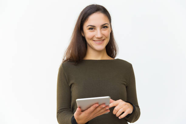 istock Front view of smiling young woman using tablet 1206136153