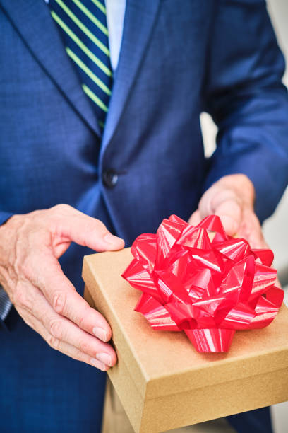 istock Male hands holding a gift box 1206138812