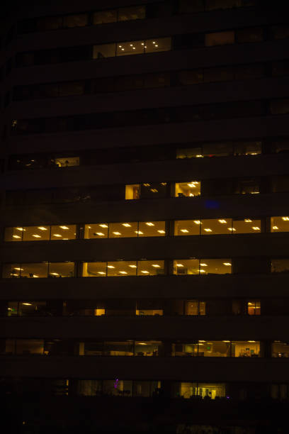 istock Tall building, skyscraper, at night, people at work at the office, overtime.Vertical shot 1206140469