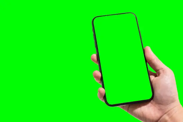 Close-up of female use Hand holding smartphone blurred images touch of green screen background.