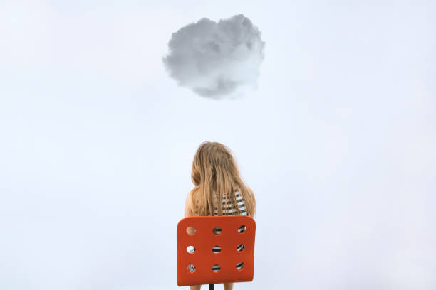 Teenager in depression Girl sitting on red chair under dark cloud. Mental health concept. Teenager in depression. Kid at reception of psychologist. Sadness and bad mood. Background with copyspace. Stock photo. animal embryo photos stock pictures, royalty-free photos & images