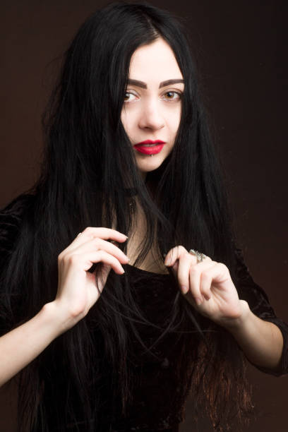 istock brunette on dark background dressed in goth style 1206143597
