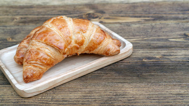 istock Croissant on a wooden table. 1206145397