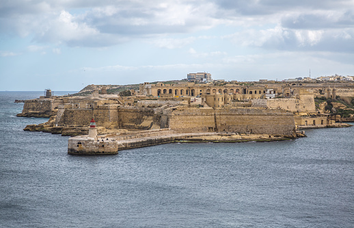 World War II Siege Bell War Memorial overlooking the Grand Harbor and Fort St. Angelo, Valletta, Malta
