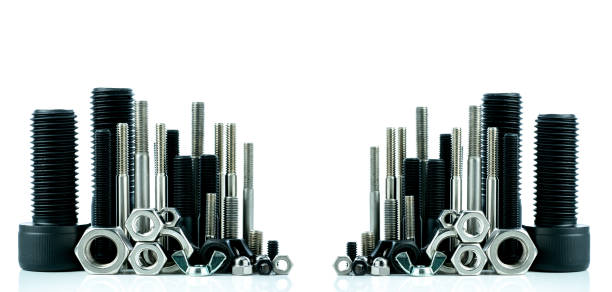 Metal bolts and nuts on white background. Fasteners equipment. Hardware tools. Stud bolt, hex nuts, and hex head bolts in workshop. Threaded fastener use in automotive engineering. Hexagonal bolt.