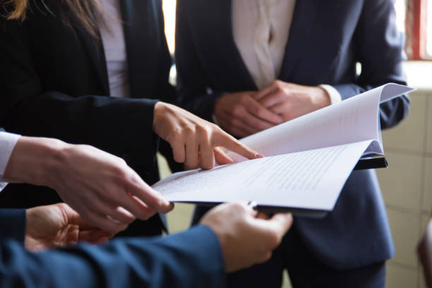 istock Cropped view of businesswomen reading document 1206146529