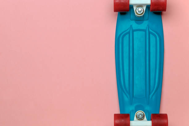 istock Skateboard cruiser with blue deck and red wheels on pink background, top view with copy-space. Concept of sport lifestyle, culture, leisure, hobby, alternative transport 1206146585