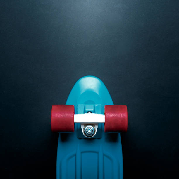 istock Skateboard with blue deck and red wheels on black background with copy-space top view. Concept of sport lifestyle, culture, leisure, hobby, alternative transport 1206146626