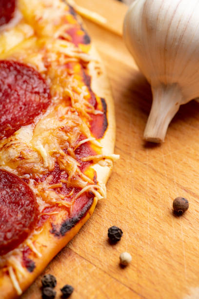 istock Fresh pepperoni pizza served on the wooden board 1206150423