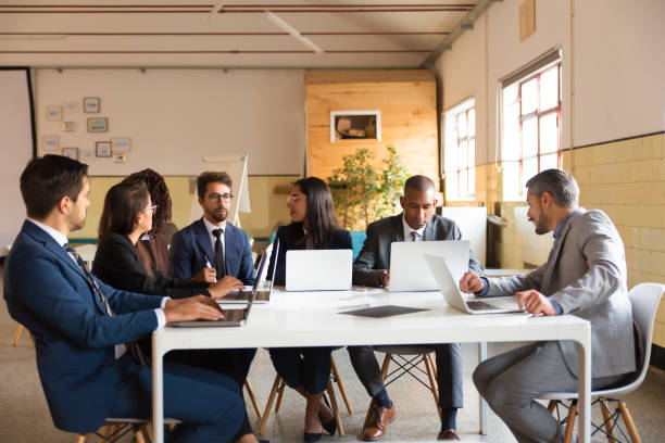 istock Focused colleagues working with laptops in office 1206152735