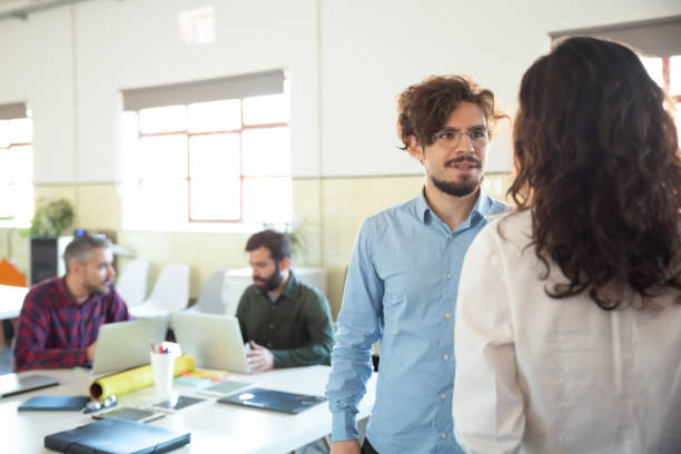 istock Confident bearded man in eyeglasses talking with woman 1206154970