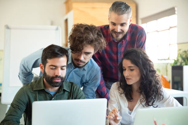 istock Confident young coworkers looking at laptop 1206156280