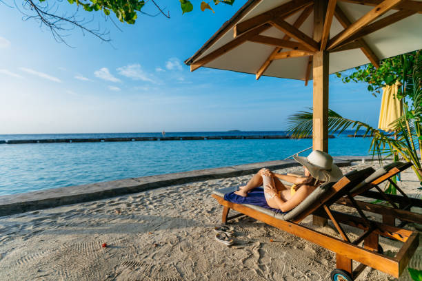 istock Young woman applying suntan lotion 1206157830
