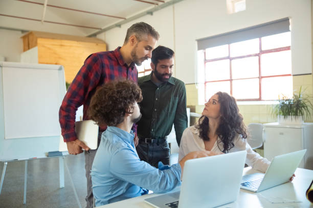 istock Focused young coworkers talking in office 1206158587