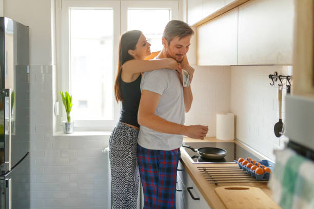 istock Girlfriend hugging her boyfriend in kitchen 1206160626