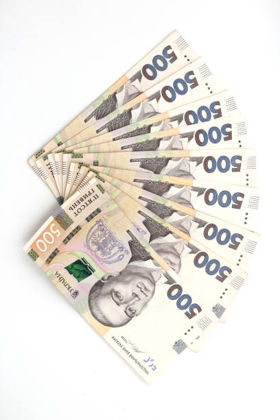 a lot of new banknotes in denominations of 500 ukrainian hryvnias isolated on a white background with shadow. european money exchange. ukraine currency. selective focus - debt national landmark credit card paying imagens e fotografias de stock