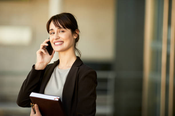 istock Collage student talking on the phone and looking at camera. 1206170684