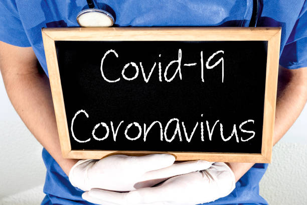 Doctor shows information on blackboard: coronavirus.  Medical concept.