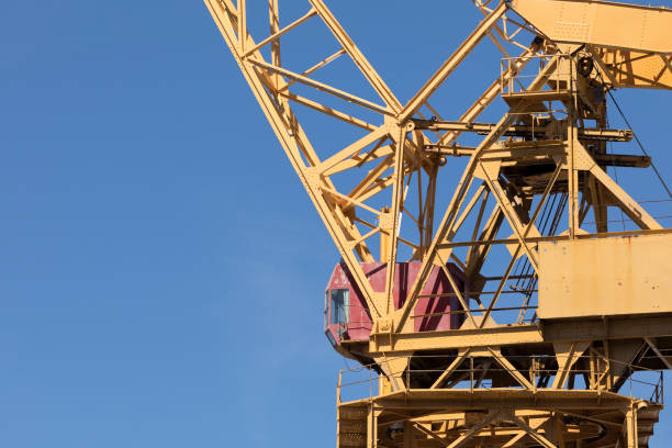 crane working in the port of cádiz, spain - crane shipyard construction pulley imagens e fotografias de stock