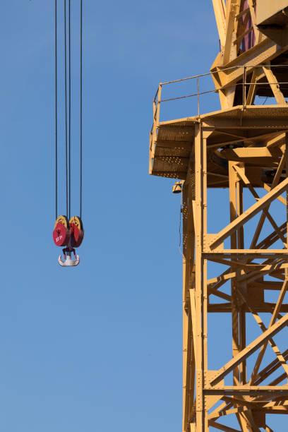 crane working in the port of cádiz, spain - crane shipyard construction pulley imagens e fotografias de stock