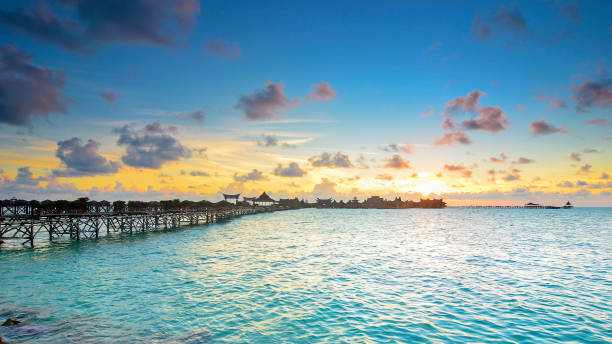 istock Long bridge heading to beautiful resort at Mabul Island during sunset 1206174455