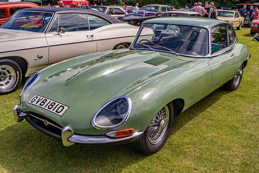 Front view of a British classic sports car, a Jaguar E Type, on display at the classic and vintage car show at Wroxham, Norfolk, UK