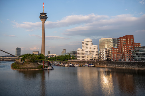 Düsseldorf, Germany; The Düsseldorf Medienhafen with the Düsseldorf TV tower and marina in the evening.