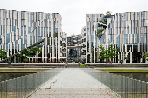 Düsseldorf, Germany - May 06, 2019: The Kö-Bogen at the Königsallee in Düsseldorf on a cloudy day. The Kö-Bogen is a mixed used building for stores and business, designed by New York architect Daniel Libeskind in 2014.