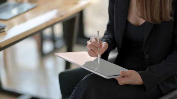 istock Cropped shot of freelancer drawing on blank screen tablet while sitting in simple workplace 1206178512