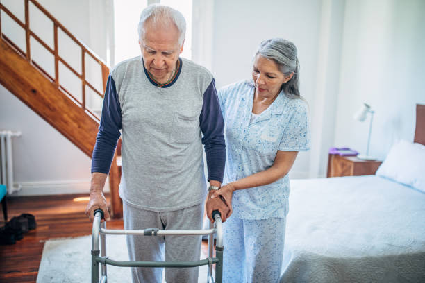 istock Senior wife helping her husband with mobility walker 1206179209