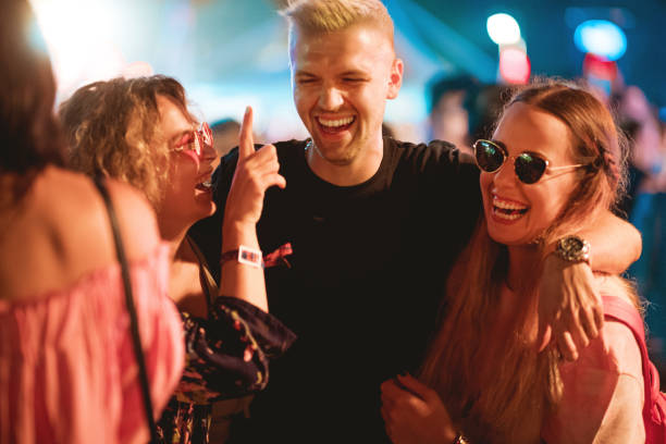 istock Friends laughing and walking through crowd 1206181830