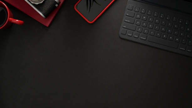 istock Top view of workplace with wireless keyboard, smartphone, copy space and camera on black table 1206182483