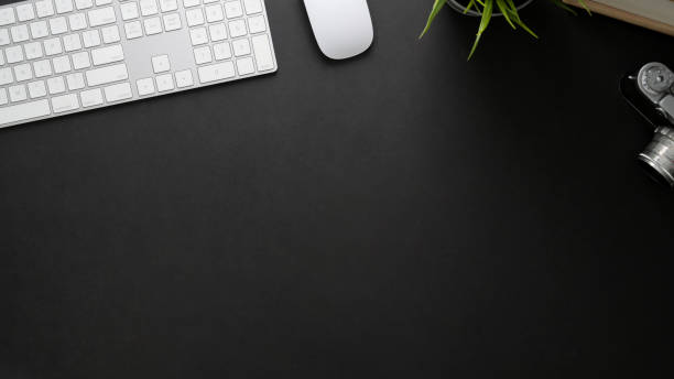 istock Top view of workplace with computer keyboard, copy space and camera on black table 1206182686