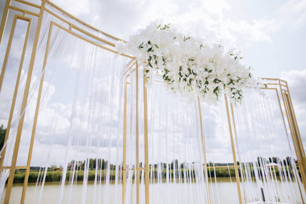 istock Beautiful white arch  for the wedding ceremony  on the lake 1206183601