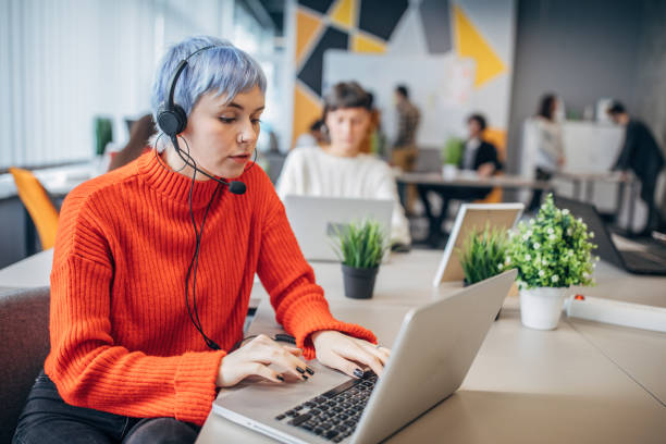 istock Beautiful woman working on laptop in big modern office 1206186076