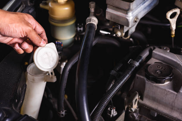 istock Hand of Mechanic technician service check level water on wiper lid can 1206187448