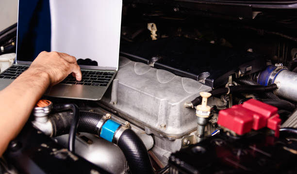 istock Professional car repair or maintenance mechanic engine working service with laptop computer 1206187523