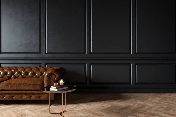 istock Modern classic black interior with capitone chester leather brown sofa, coffee table, wood floor, mouldings. 3d render interior mock up. 1206189644
