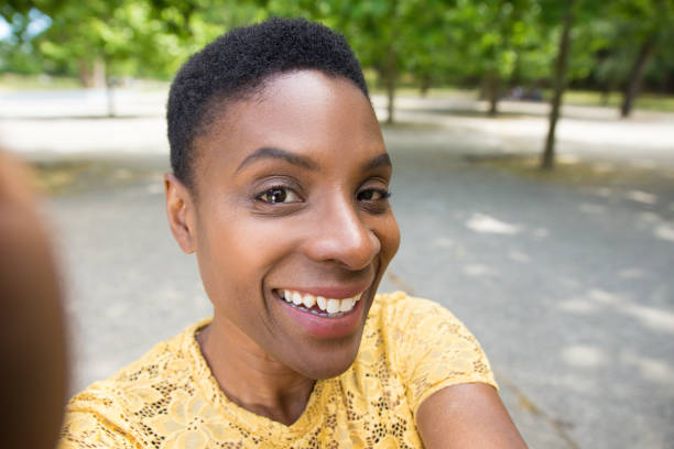 istock Joyful mature woman looking at camera while taking selfie 1206189885