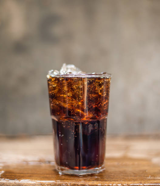 istock Soft drink and ice splashing on wood table. 1206191371