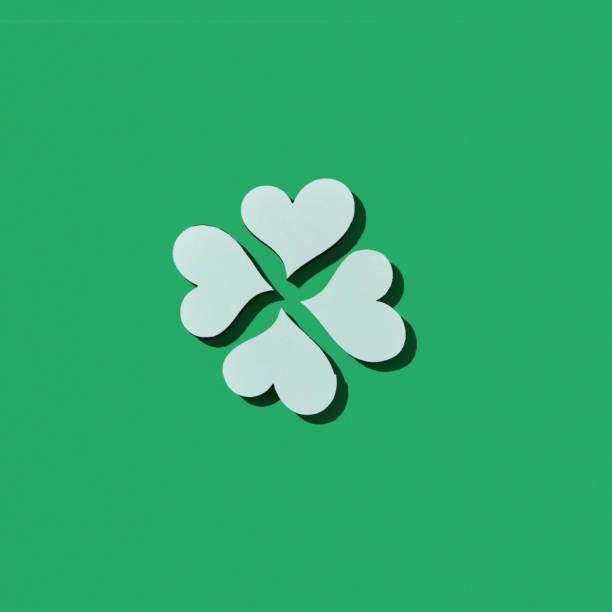 istock Handcraft paper white clover's four petals with shadows. 1206194142