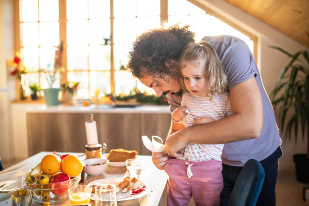 istock Single father cleaning his daughter after breakfast at home 1206196168