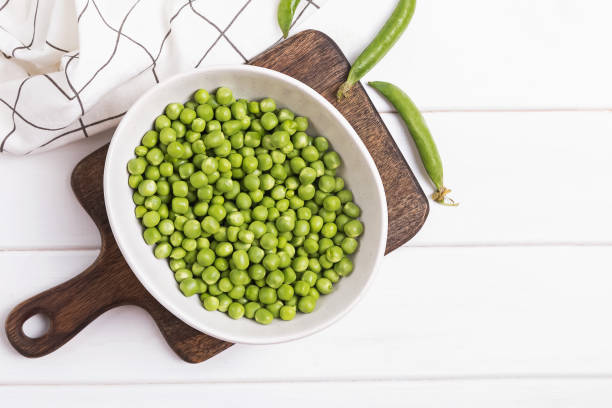 istock A bowl of fresh green peas on the white table 1206196713