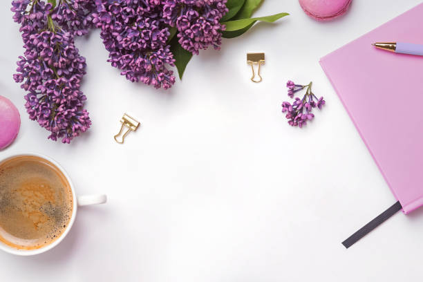 istock Creative composition with feminine accessories, beautiful lilac flowers, coffee and macarons 1206196827